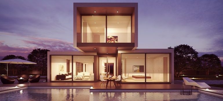 The exterior of a modern house with a pool.