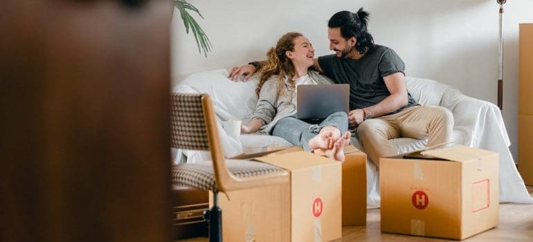 couple looking online for moving services Northern VA has to offer