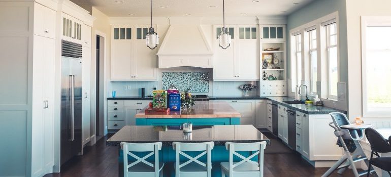 A kitchen with blue details that will be relocated by our movers Burke VA residents trust