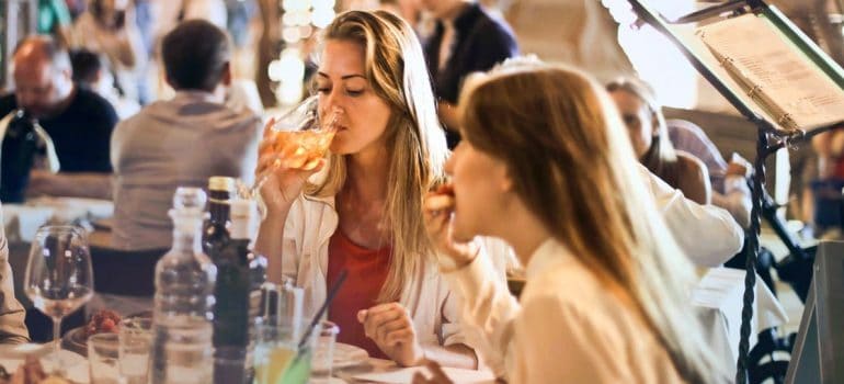 Two girls having food and drinks in the restaurant