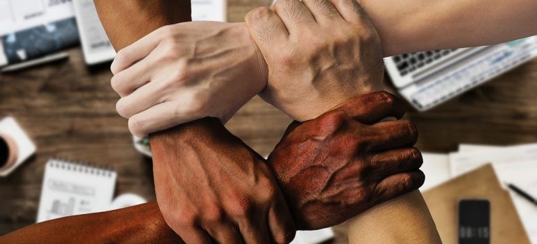 An image of people holding hands, representing team building at one of the top moving companies Fort Belvoir VA has to offer