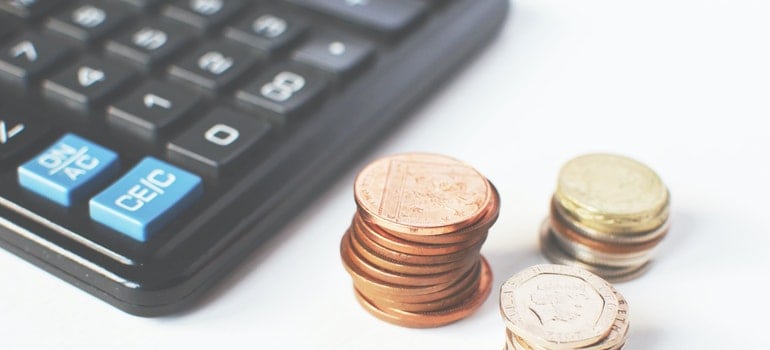 Coins beside a calculator