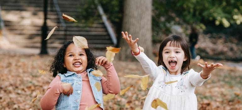 Kids play with leaves.