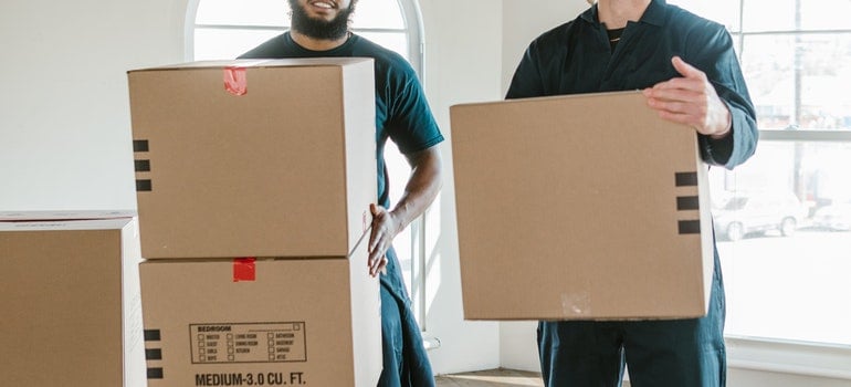 movers holding boxes