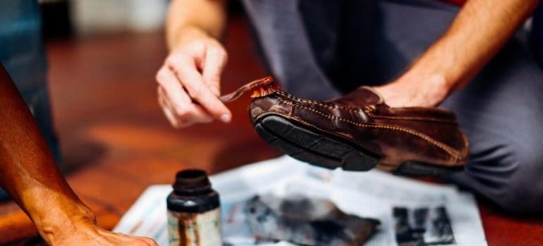 Person cleaning shoes before packing them