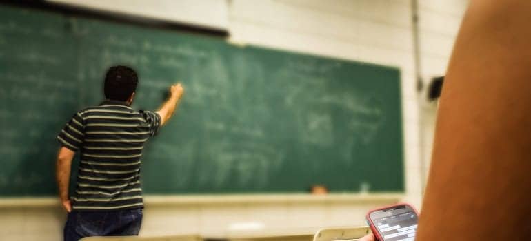 Teacher living in Springfield VA writing on the board