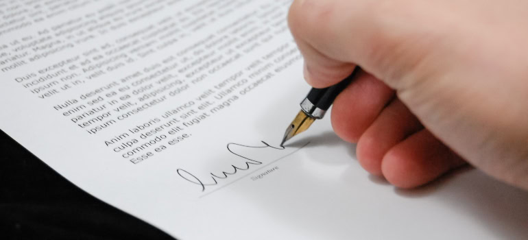 Man signing a document after he find a reputable company