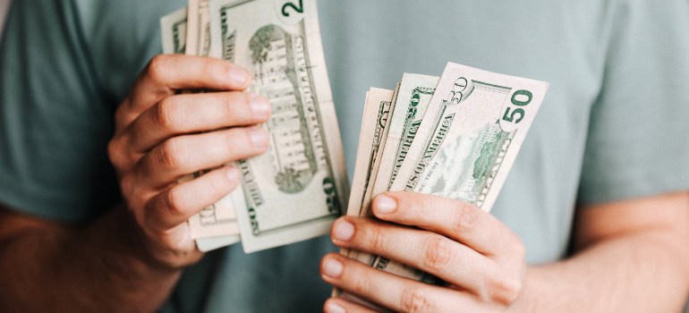 A man counting money before moving from Quantico to McLean