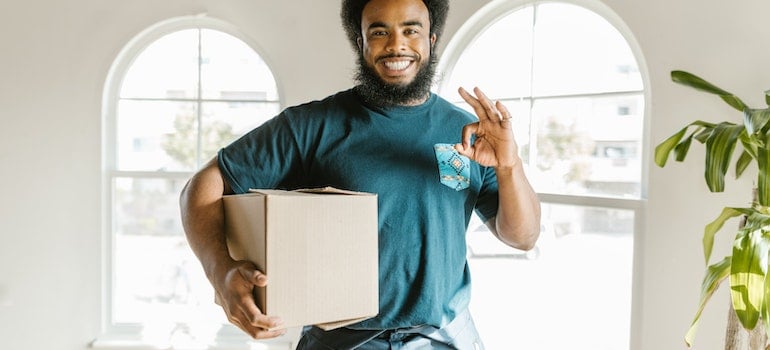 Professional mover holding a box 