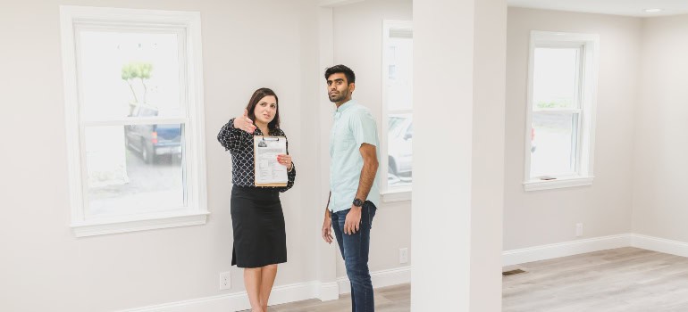 A real estate agent helping a man look at a home