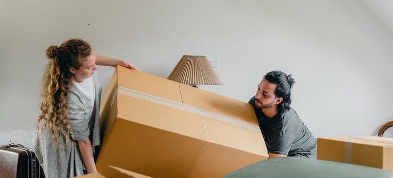 Couple carrying a box