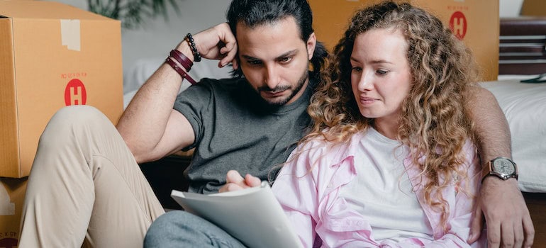 picture of man and woman looking at a book