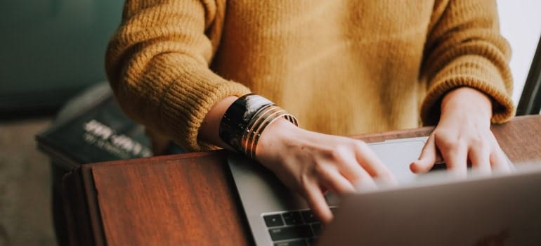 Picture of a person looking at a laptop