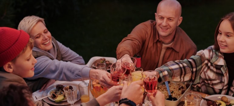 A group of friends toasting at dinner.