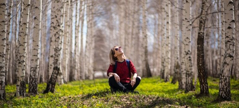 a woman sitting in a forest