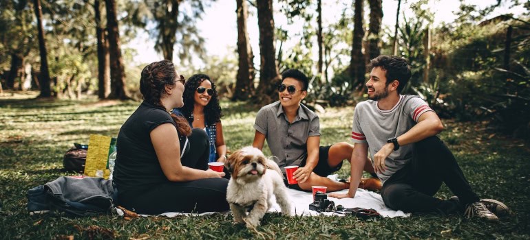 A group of people are sitting in a park.