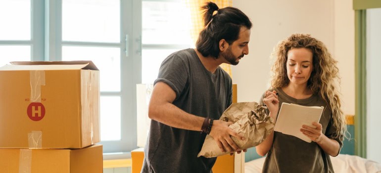 A man and a woman are packing to move.