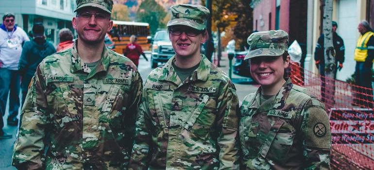 Three people wearing military uniforms.