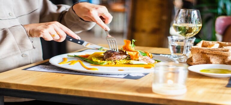 A person eating a delicious meal at a restaurant.