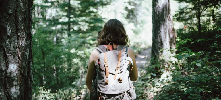 A person with a backpack enjoying nature which is something people living in Fairfax get to do often.