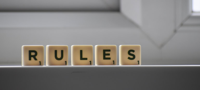 What should you do immediately after your move? Check the local rules, which are spelled with scrabble tiles in this picture.