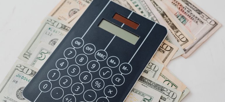 a modern calculator on top of dollar bills