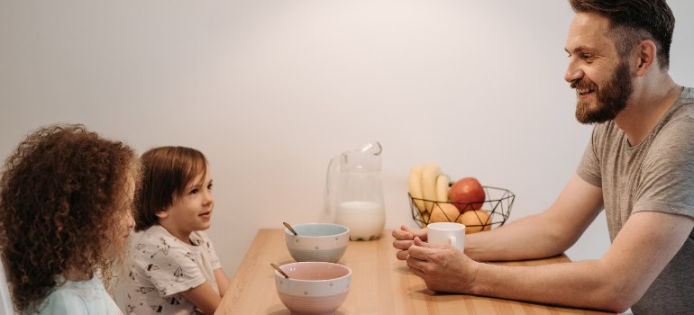 A man talking to his two children before making the move interstate as a co-parent.