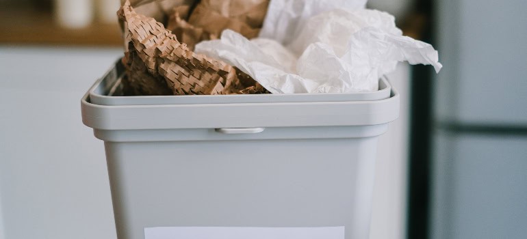 a recycling bin with paper in it