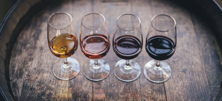 four glasses with various types of wine in them