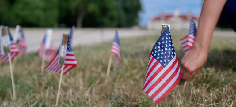 a yard with many tiny American flags placed in it