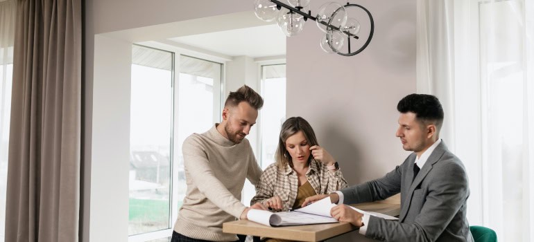 two people in an elegant talking to a realtor who can help them find a dream home in Arlington