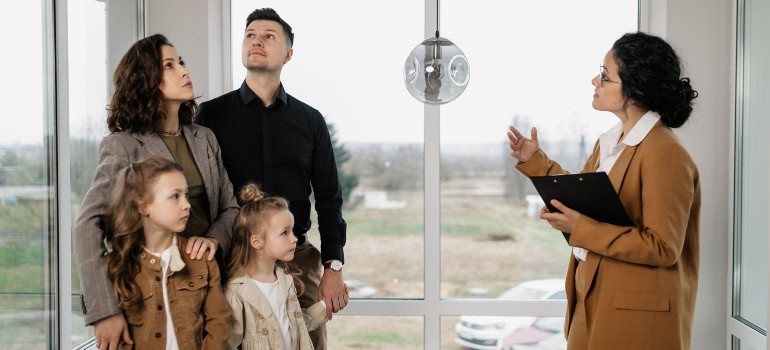 a family of four viewing a house 