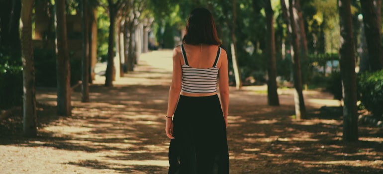 a woman admiring nature in the park which is what you should do if you are wondering how to start over in Woodbridge