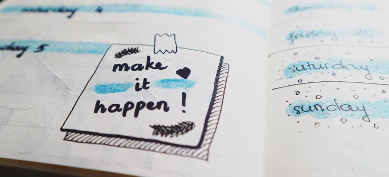 a quote written in a planner that says "Make it happen!"