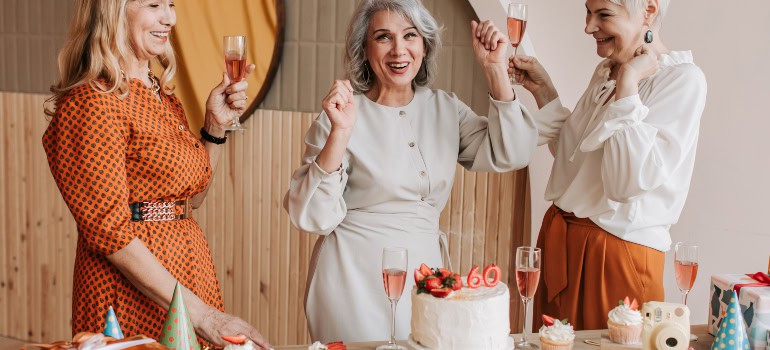 three women celebrating the sixtieth birthday of one of them