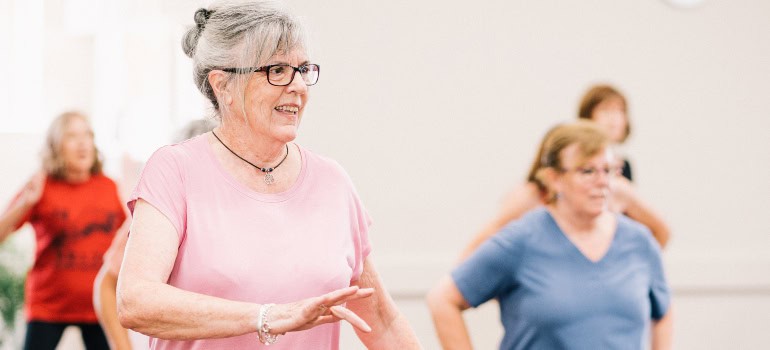 women in their golden years taking part in a recreational activity that involves dancing after moving to Annandale as a senior