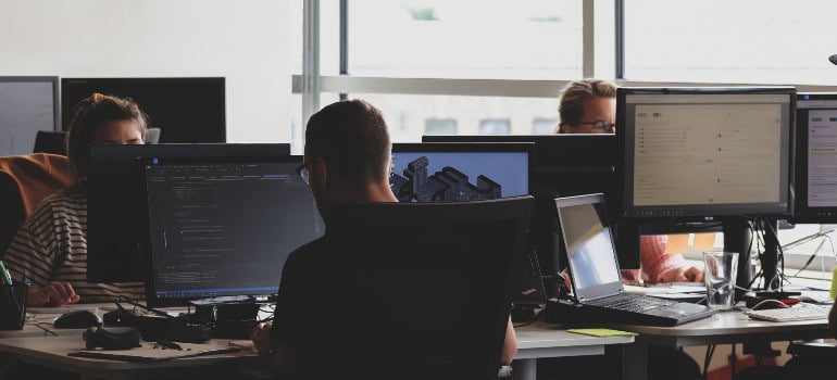 people in an office working on computers 