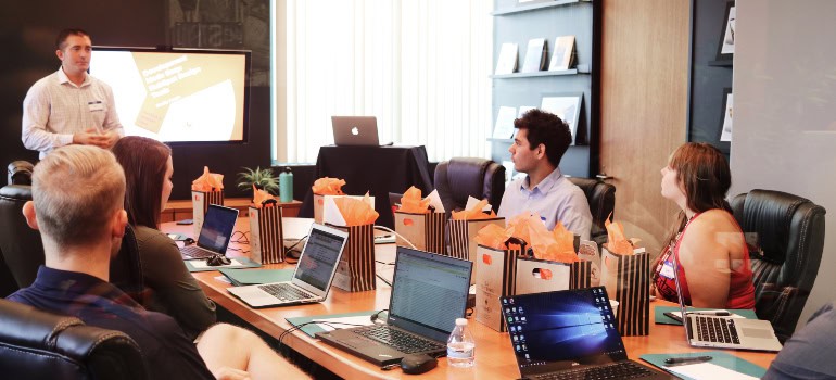 people sitting with laptops in front of them at some course 