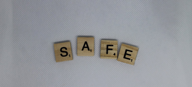 scrabble tiles spelling the word "safe"