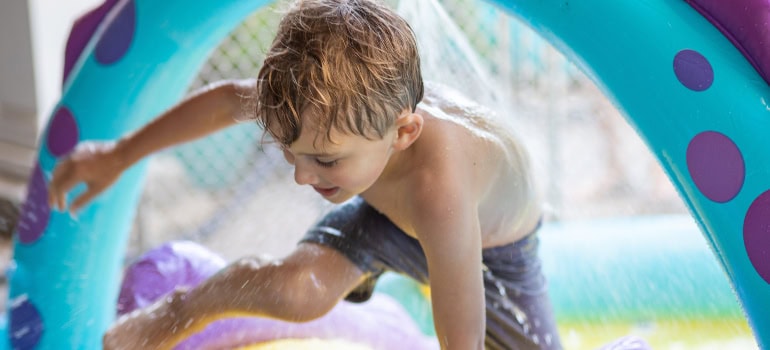 a boy playing in a water park