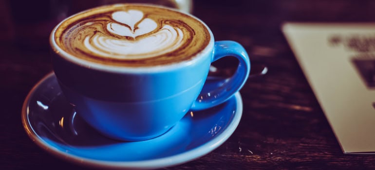 a cup of coffee with an intricate foam design