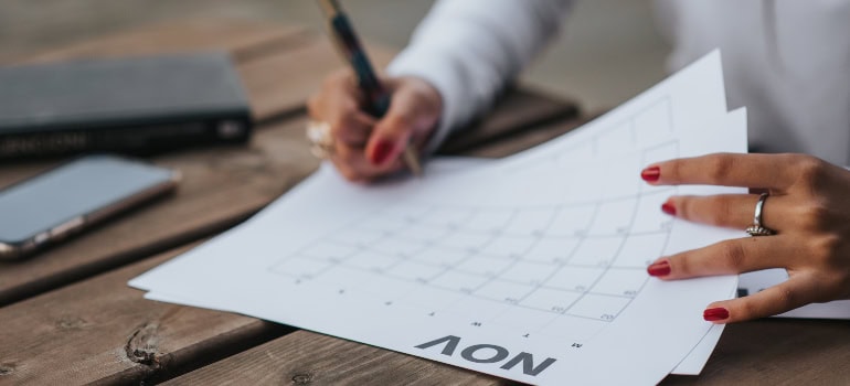 a person writing something on a calendar