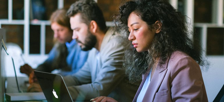 several highly-educated people working on their computers who are one of the reasons for moving a business to Manassas