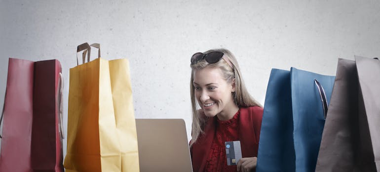 a woman smiling while doing online shopping