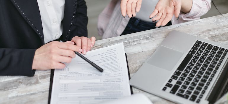 a person explaining to a woman the provisions of an insurance policy