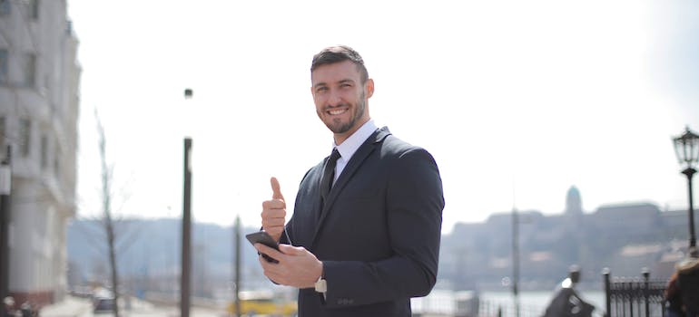 a smiling man in a suit who knows the answer to the question why is moving to Fairfax County a great idea