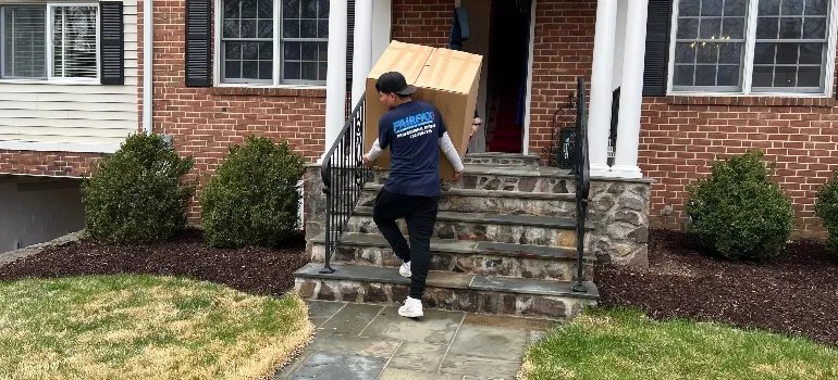 some of the movers Centreville VA offers carries a large box down the stairs