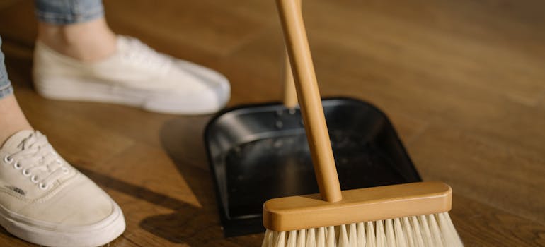 a woman cleaning the floor and wondering whether she should buy a house or apartment