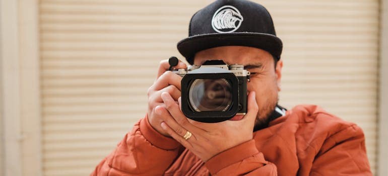 a man taking a photo with a vintage-looking camera