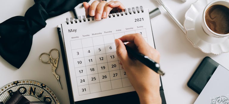 a woman holding a calendar and a pencil in her hands